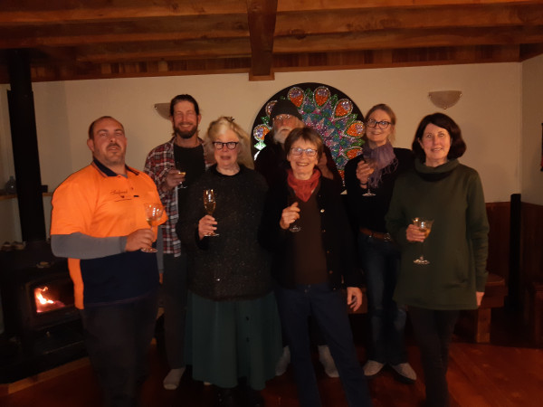 Photo of members of the Takaka Hill Biodiversity Group Trust celebrating with drinks at the successful application for funding